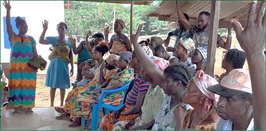 Members of the community raising their hands