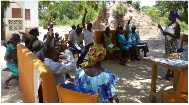 Members of the community sitting outside together.