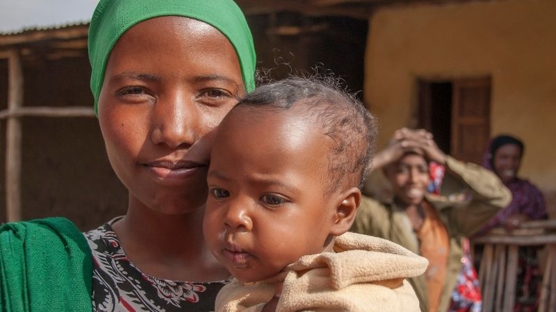 A mother holding her daughter.